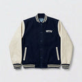 Navy and off-white varsity jacket with a brand logo on a light grey background