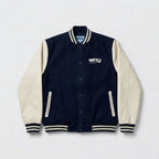 Navy and off-white varsity jacket with a brand logo on a light grey background