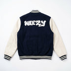 Navy and off-white varsity jacket with 'WEEZY' text on the back against a white background